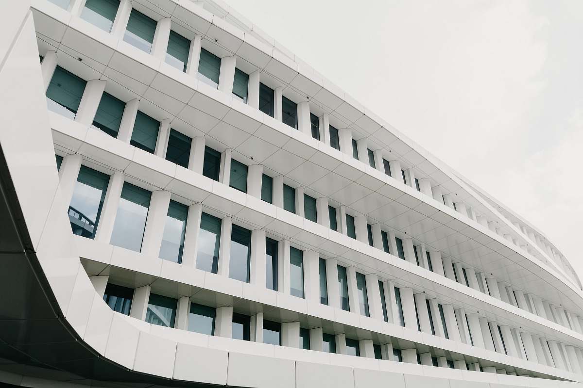 architecture white concrete building under cloudy sky during daytime grey