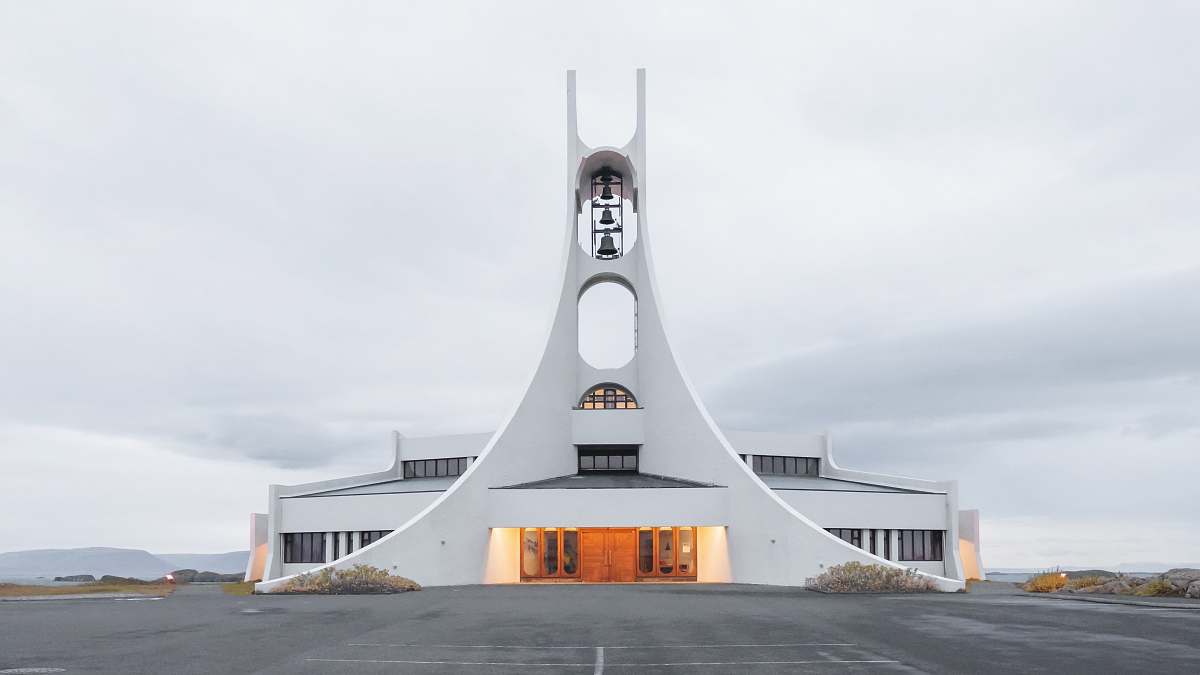 architecture white concrete building under white clouds iceland