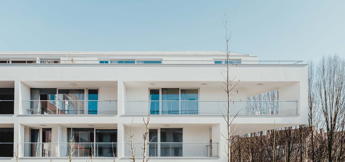 housing white painted building under blue sky house
