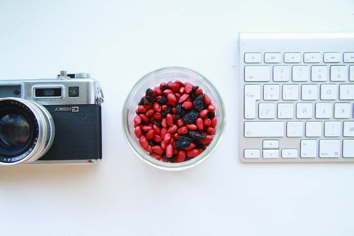 electronics black and gray SLR camera and white keyboard keyboard