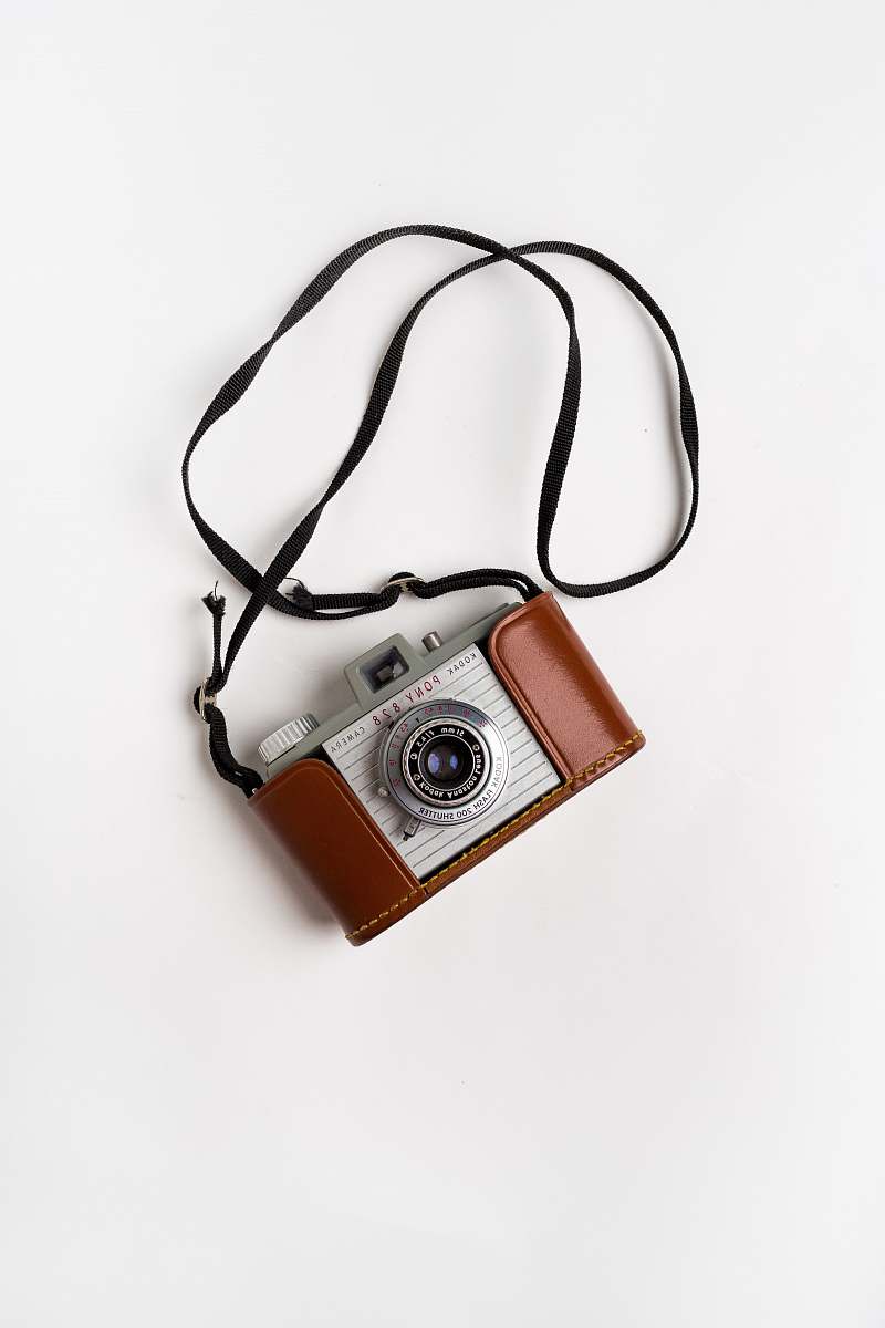 electronics brown and gray SLR camera on white surface lawrenceville