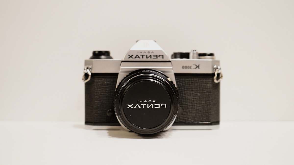 electronics round black and silver analog watch vintage pentax film camera
