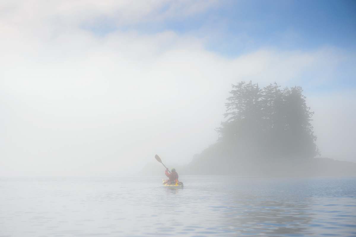 paddling person rowing boat in sea kayaking