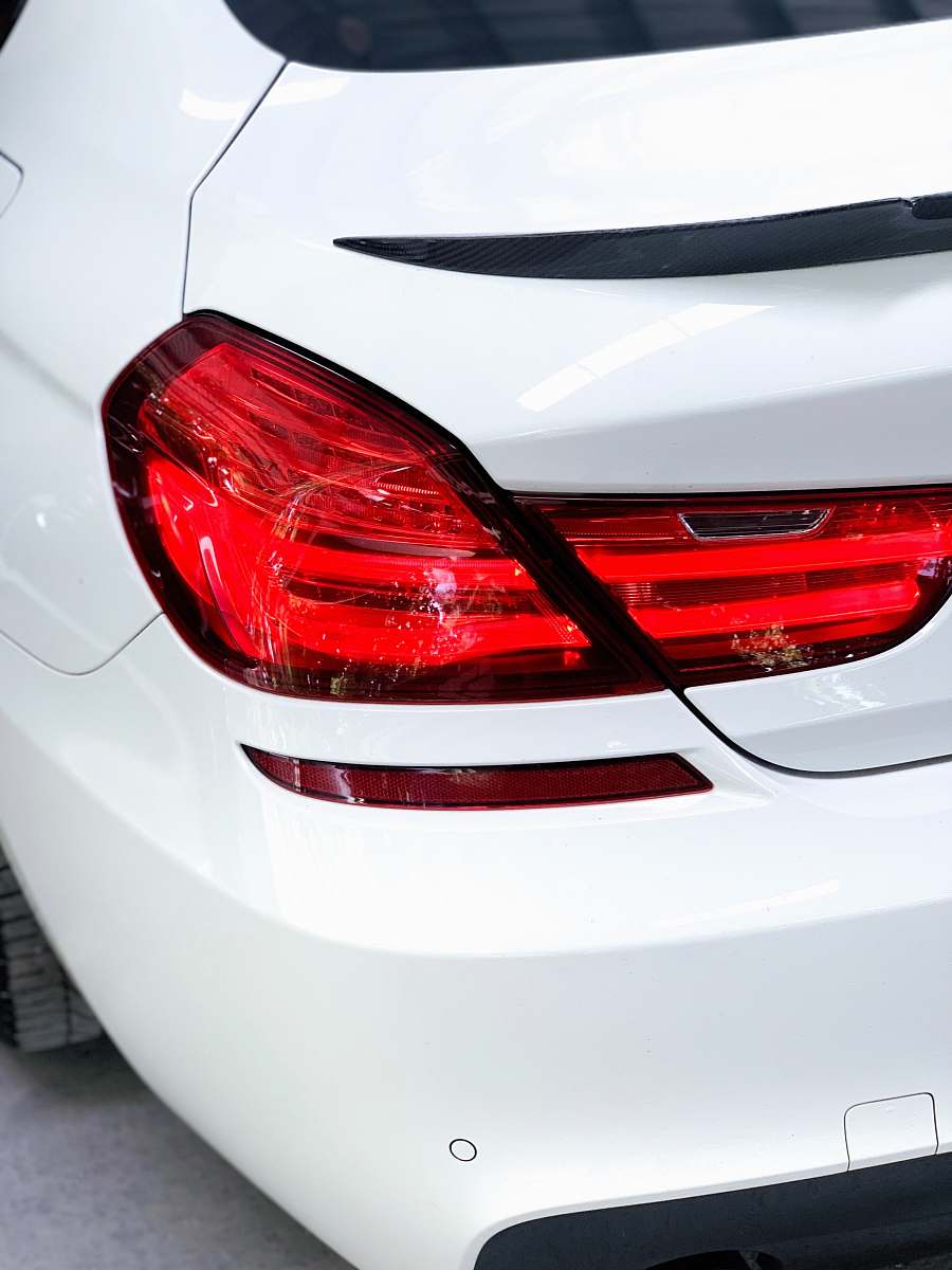 tire back view of white car machine
