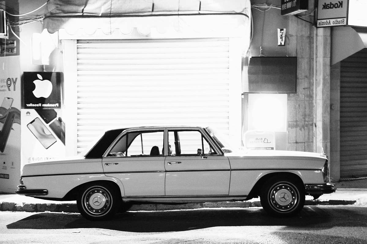 black-and-white car parked near building automobile