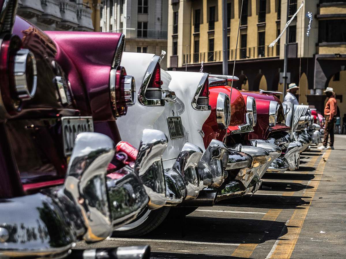 havana lined white, purple, and red vehicles cuba