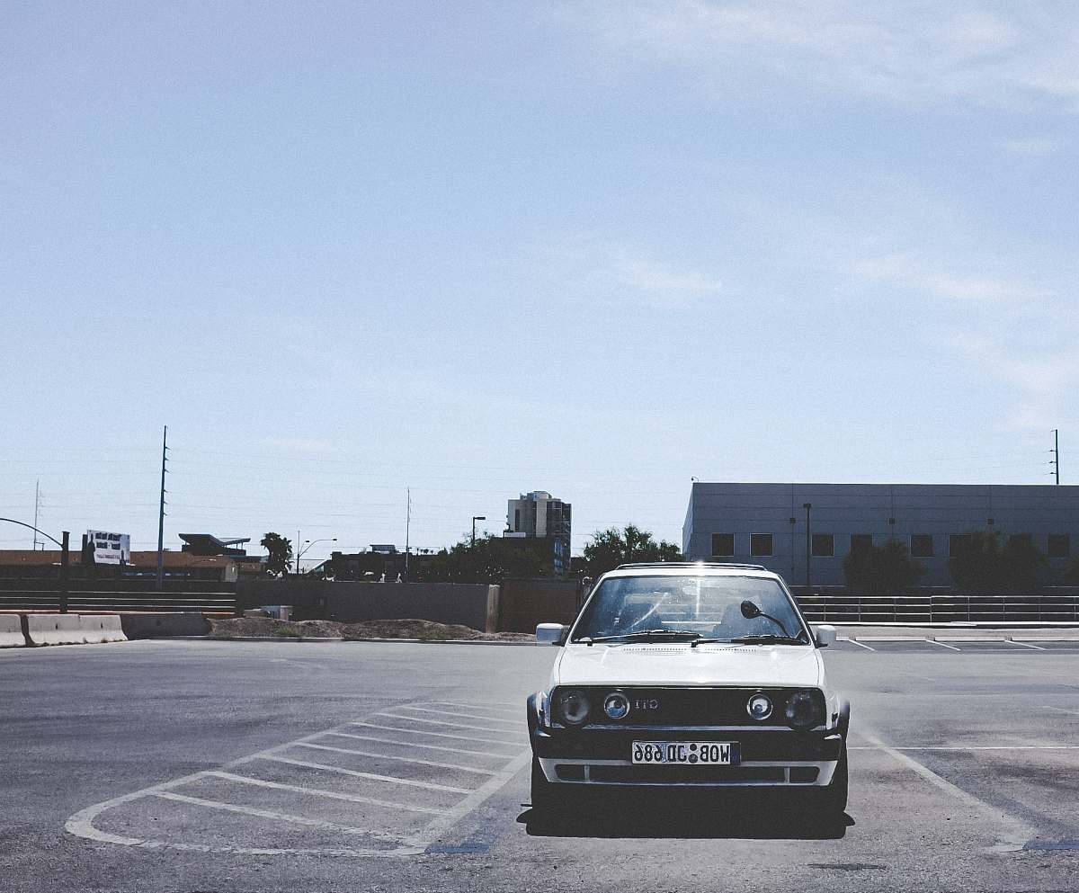 vehicle parked white car during daytime transportation
