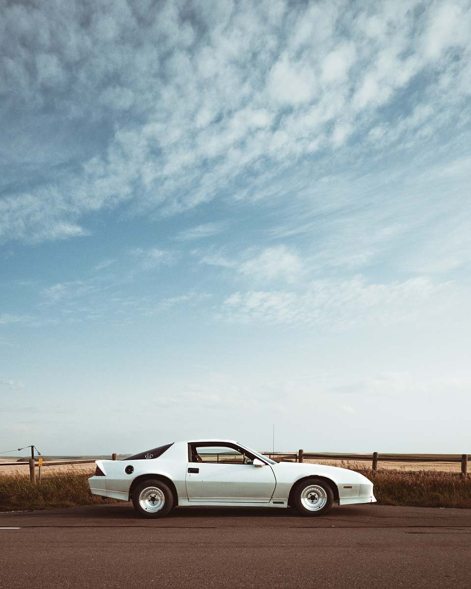 vehicle silver coupe under cloudy sky white car