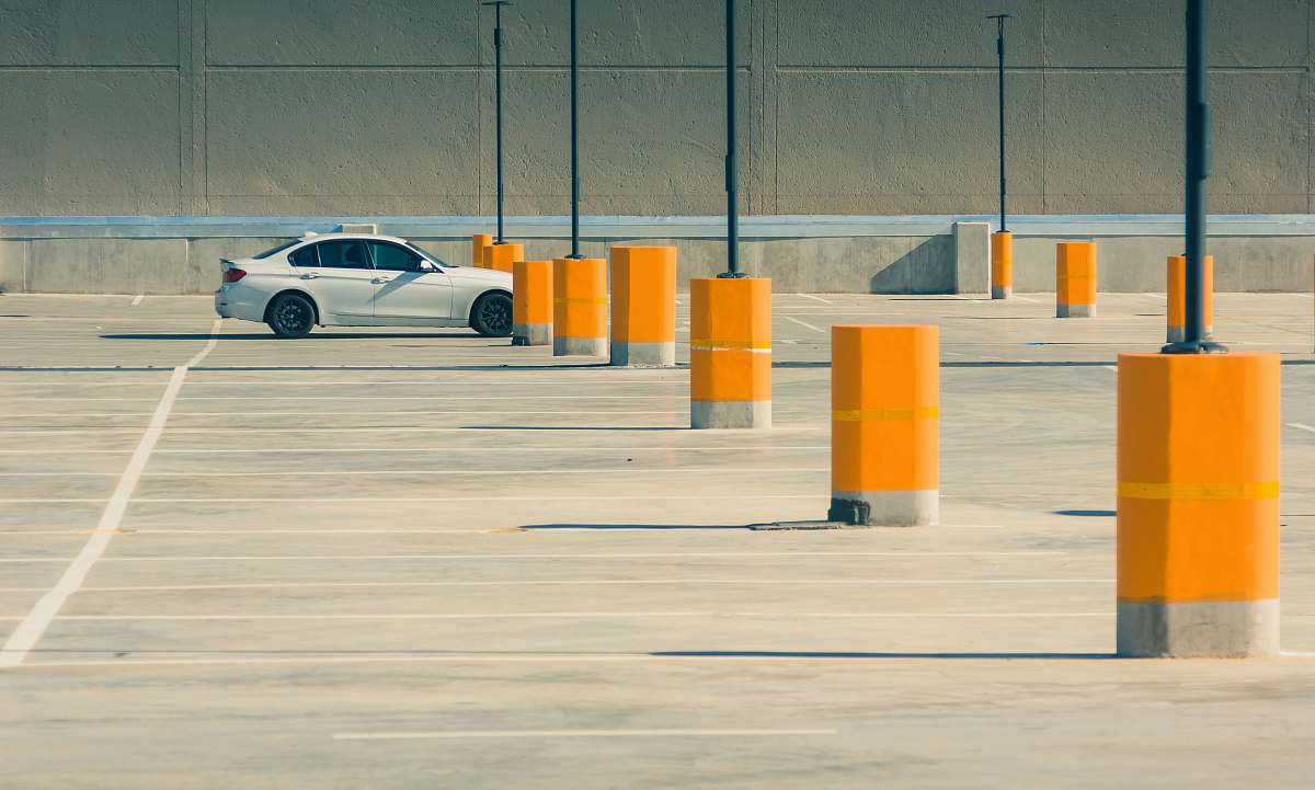 vehicle white sedan on parking lot during day time parking