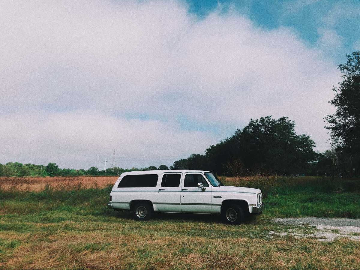 vehicle white station wagon on grass field automobile