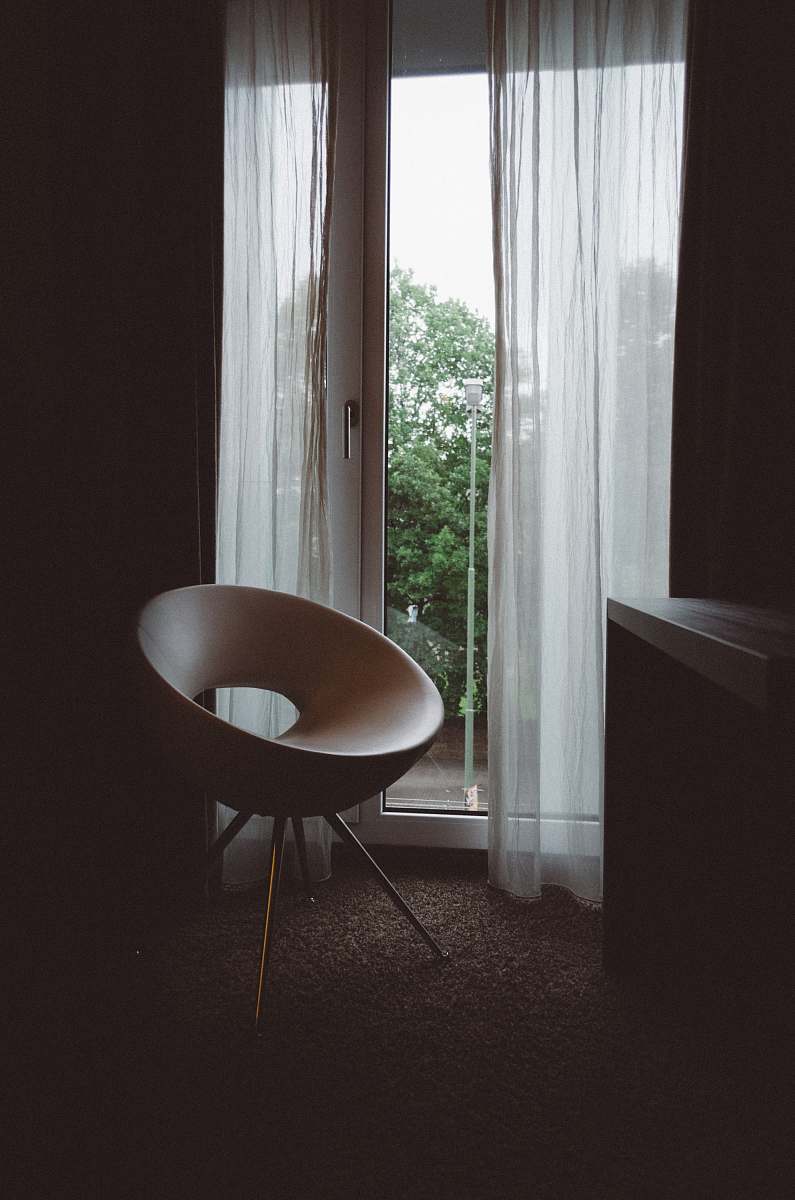 furniture brown chair beside glass door door