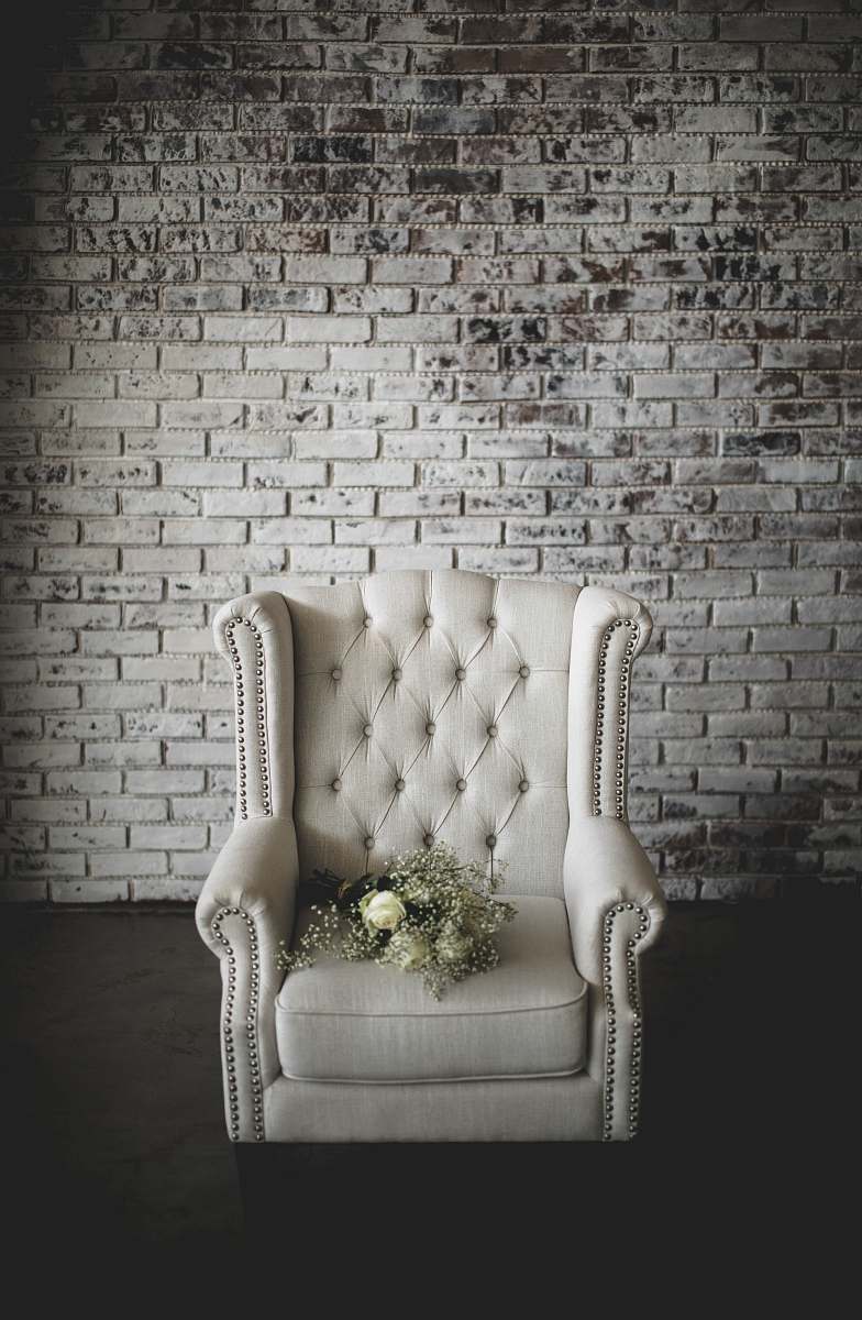furniture white flowers on top of white armchair grey