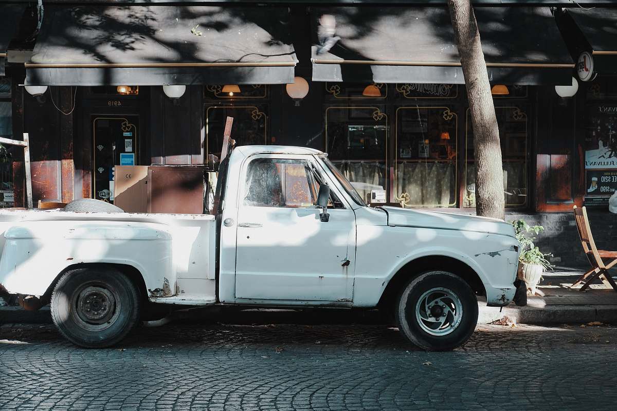palermo white single cab pickup truck parked beside road vehicle