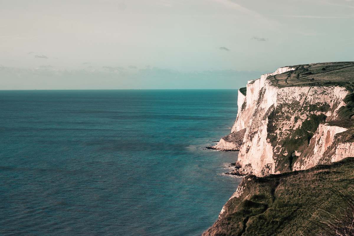 outdoors body of water beside cliff white cliffs of dover