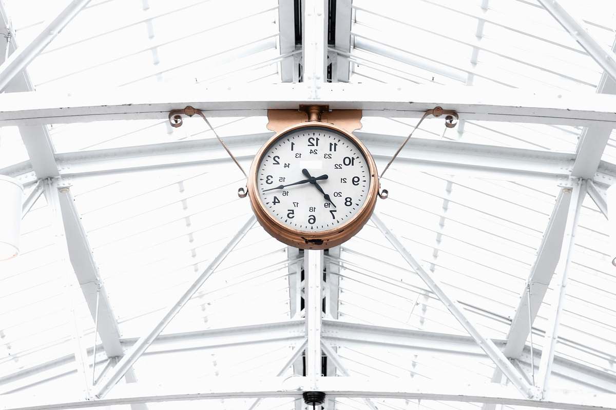 montreal round gold and white analog clock reading at 7:10 canada