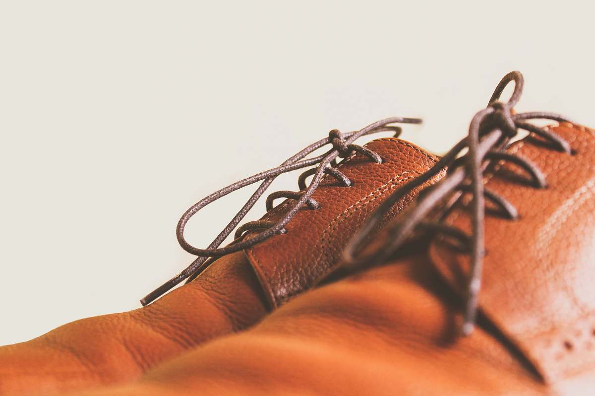 apparel closeup photo of brown leather lace-up shoes people