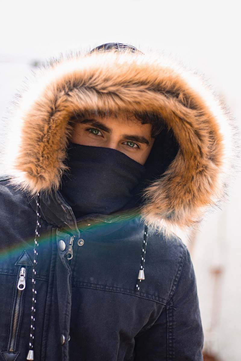 apparel selective focus photography of man wearing parka hoodie hood