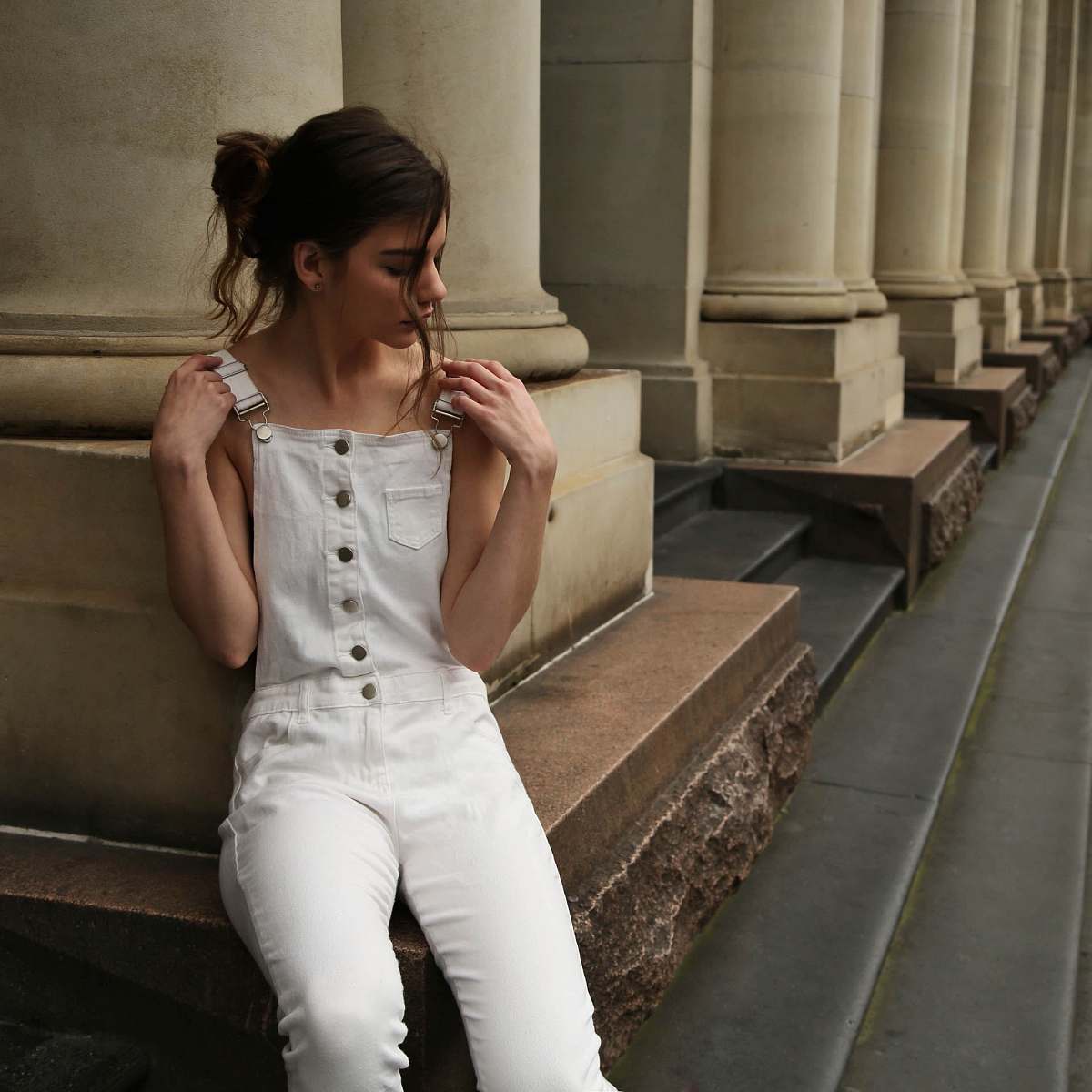 apparel woman sitting and leaning on wall human