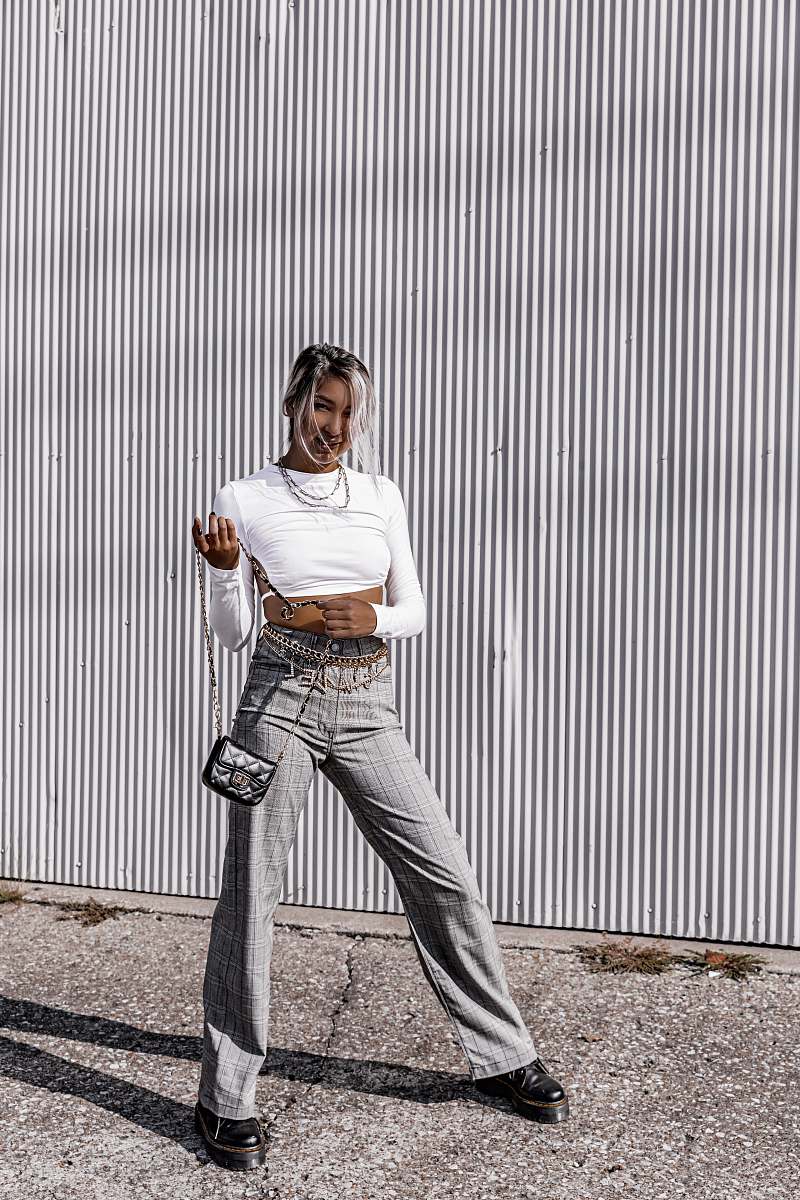 apparel woman wearing white long-sleeved shirt and gra jeans pants