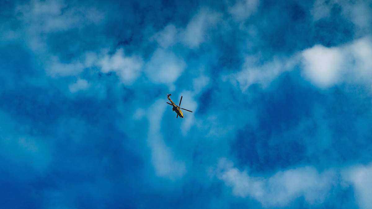 blue green and black helicopter clouds