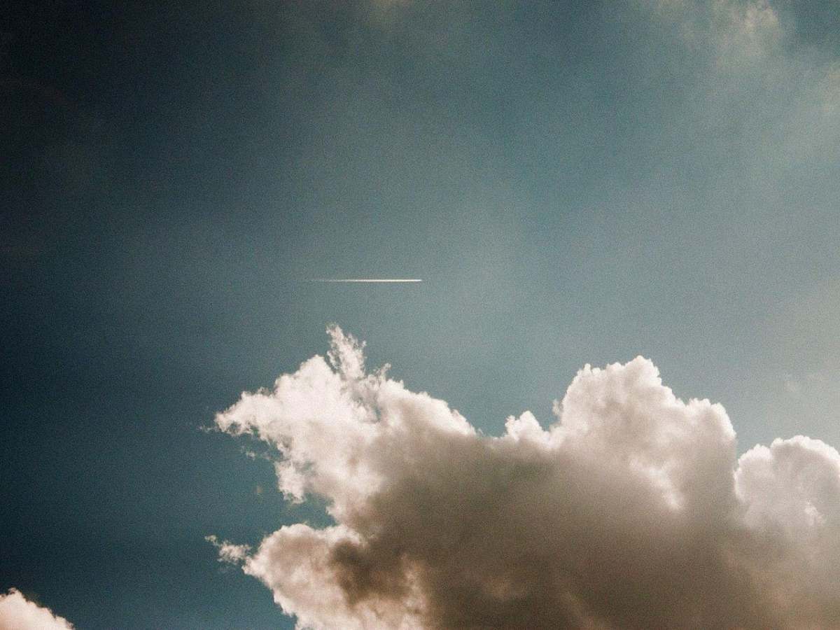 sky photo of contrail during cloudy daytime clouds