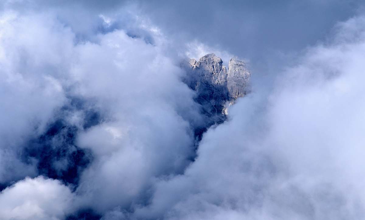 nature rock formation covered with clouds weather