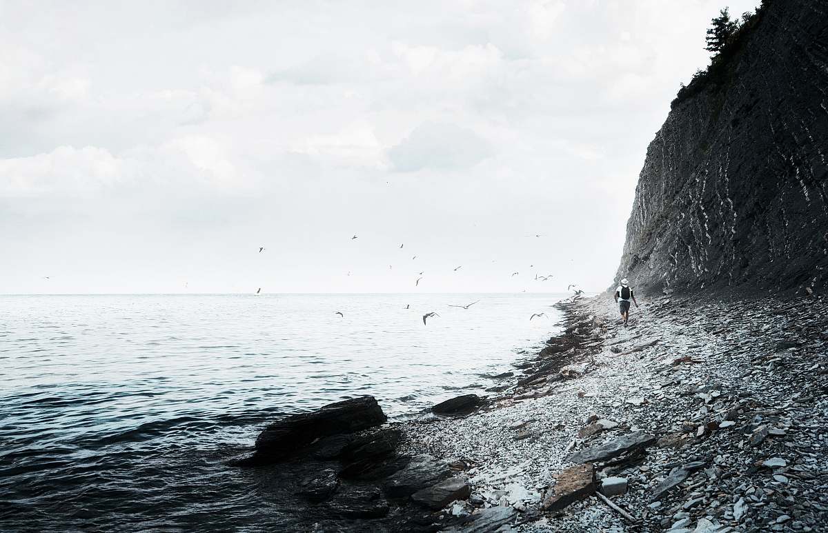 ocean person walking near seashore during daytime sea