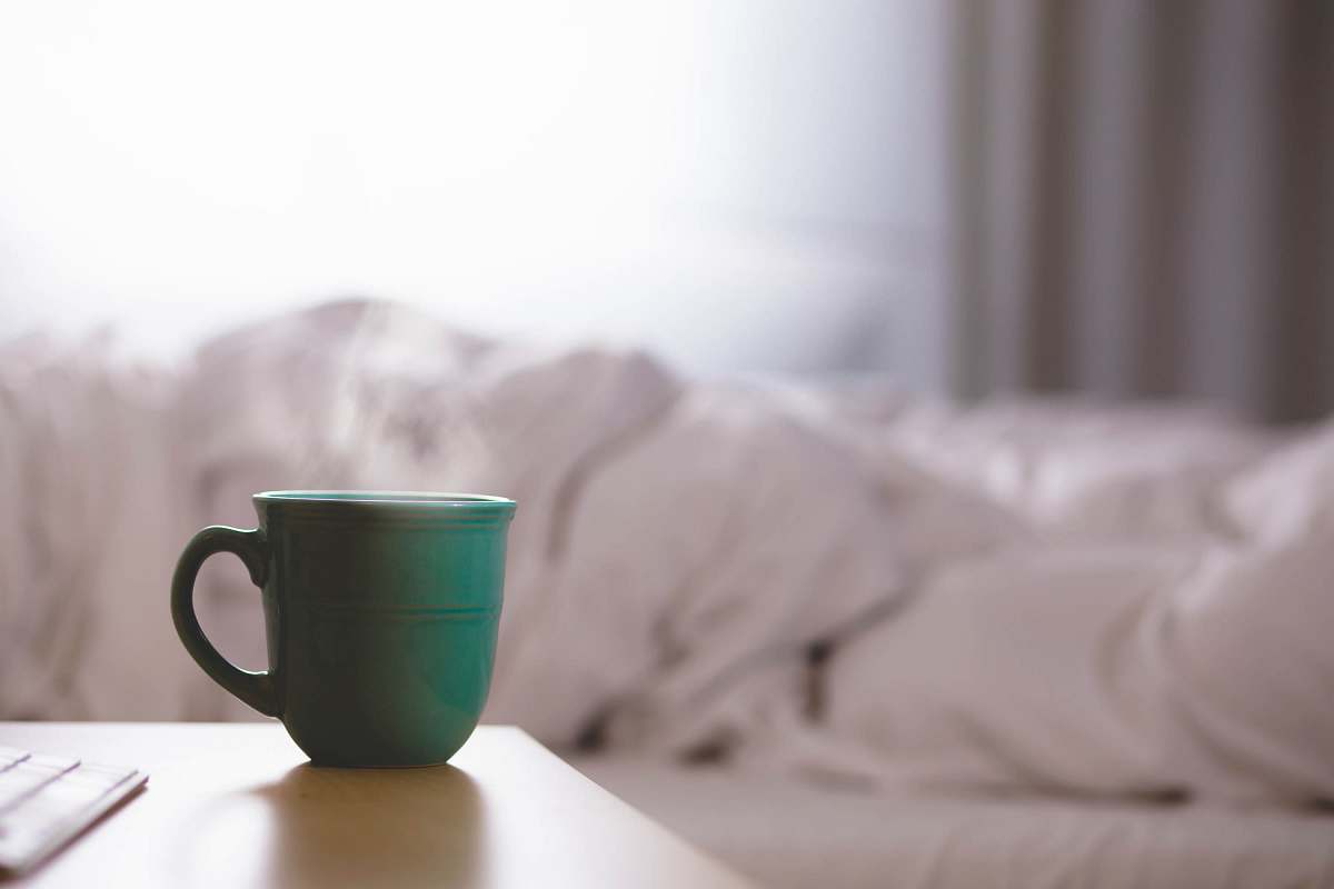 tea green ceramic mug on wooden desk cup