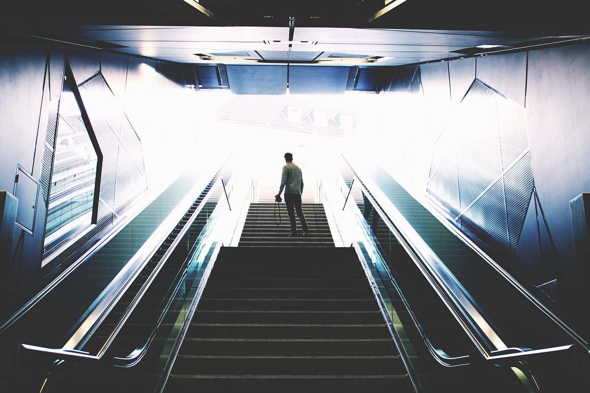 germany man standing on escalator solitude