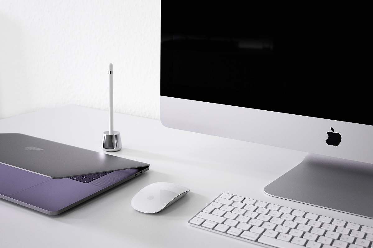 laptop silver iMac, keyboard, and mouse desk