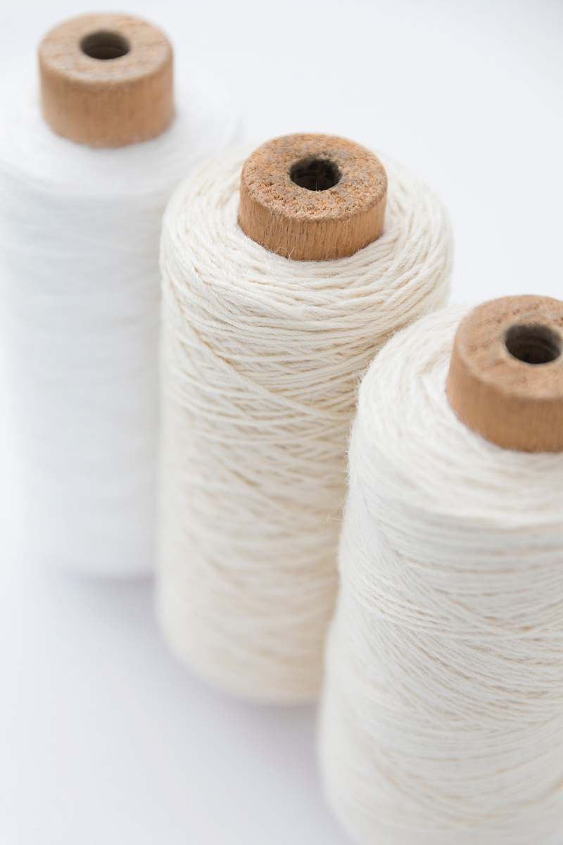 fabric three spools of white threads white