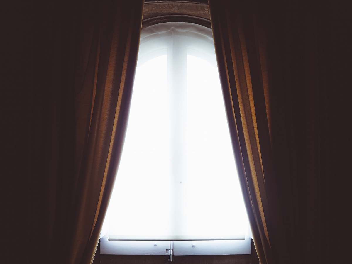 window clear glass window and brown curtain panel white