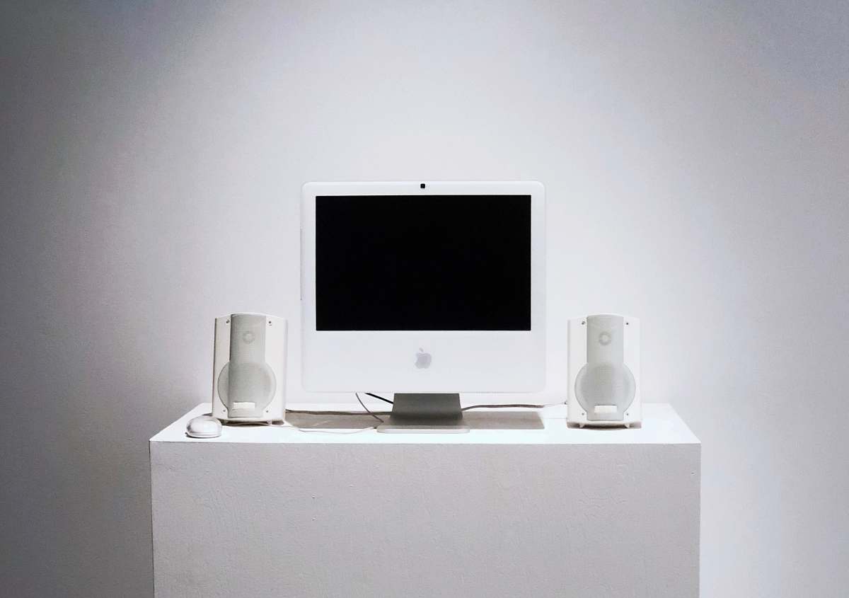 screen Apple Studio Display monitor on white table furniture