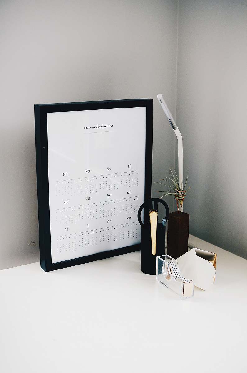 flora calendar with black frame on table jar