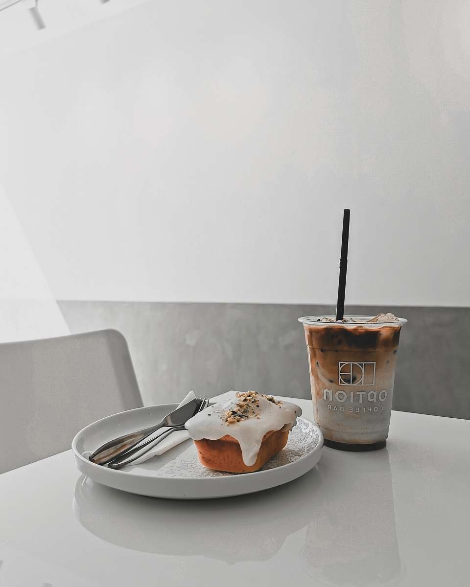 Indulge in the exquisite flavors of Thailand with this beautifully arranged plate of traditional sweets, complemented by a steaming cup of coffee. The scene captures a serene moment perfect for food lovers and culinary enthusiasts, showcasing the vibrant colors and textures of the desserts on a pristine white table. Ideal for use in articles about Asian cuisine, dessert recipes, or lifestyle blogs focusing on dining experiences.