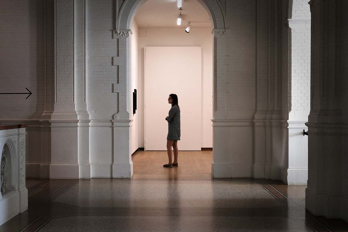 quiet woman standing at the center of arch thought