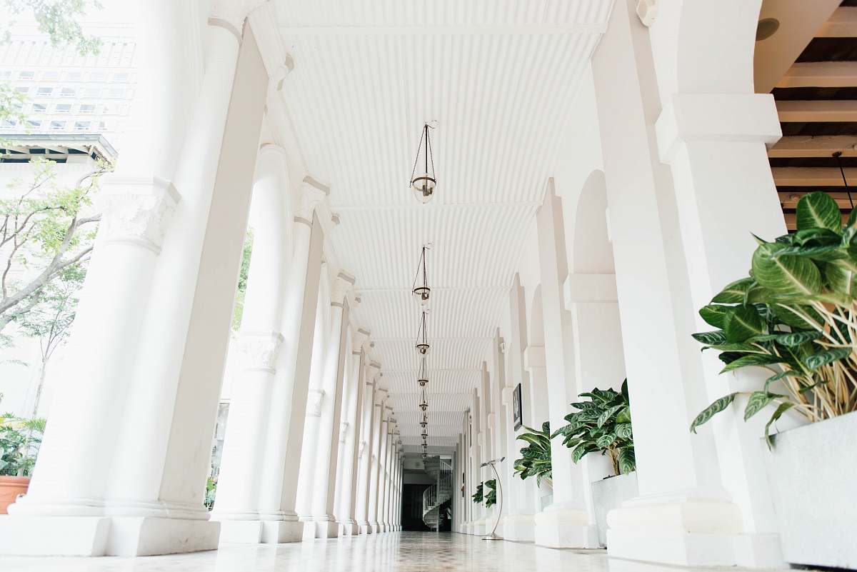 plant white ceramic tiles on hallway with pillars grey