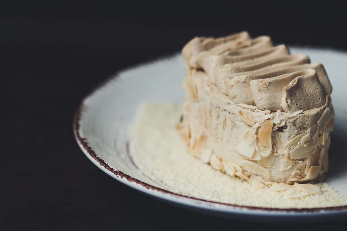 dessert beige icing-covered cake on plate cream