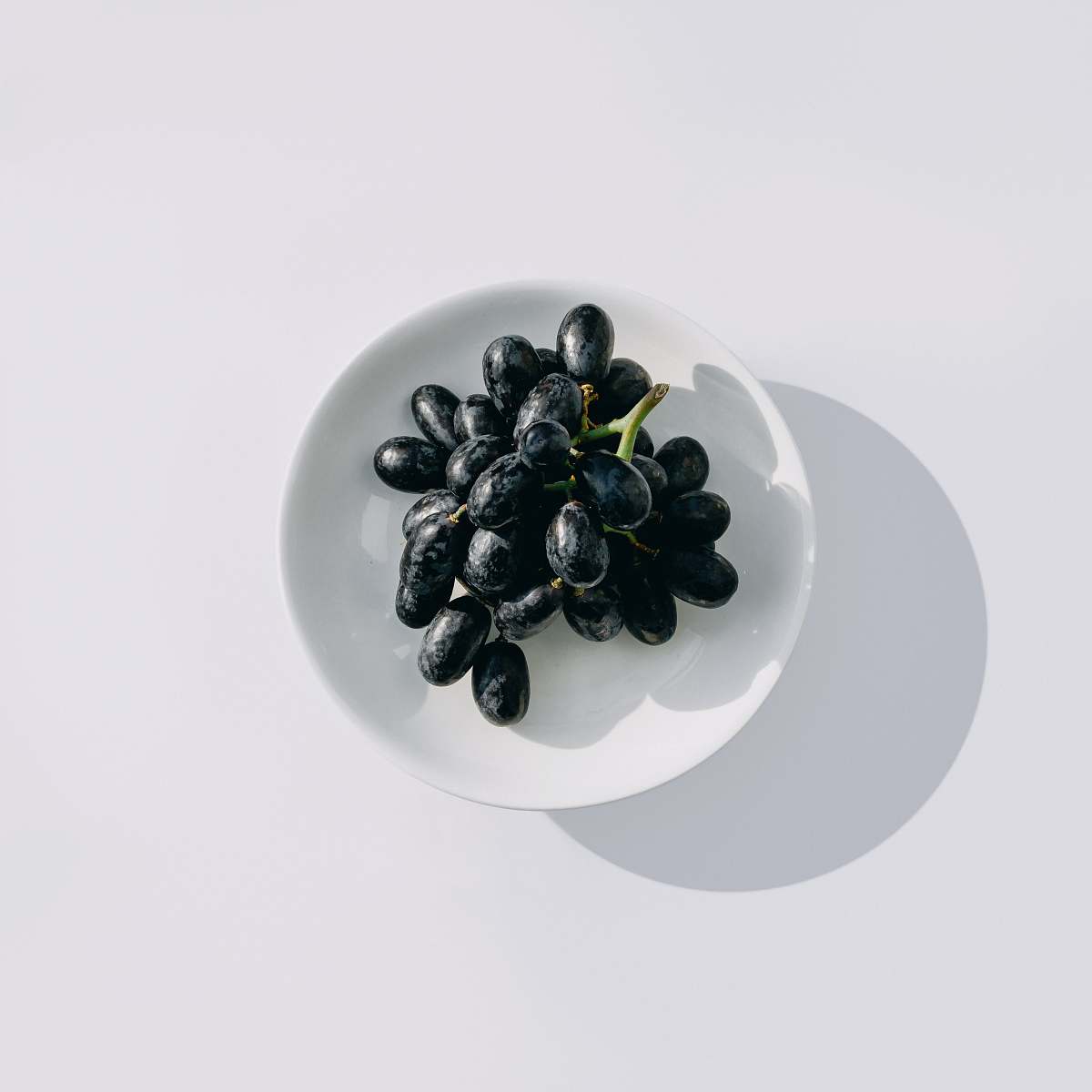 grapes java plum on white bowl fruit