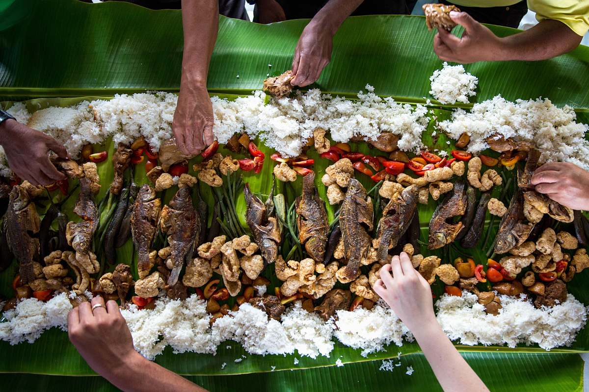meal photo of people eating rice hands