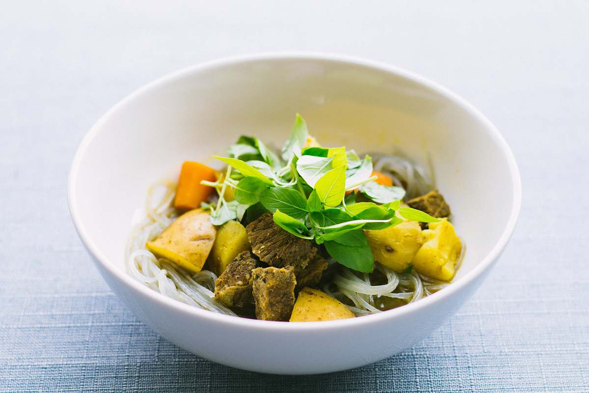 vietnam round white ceramic bowl with sliced meat and vegetable on gray surface bowl