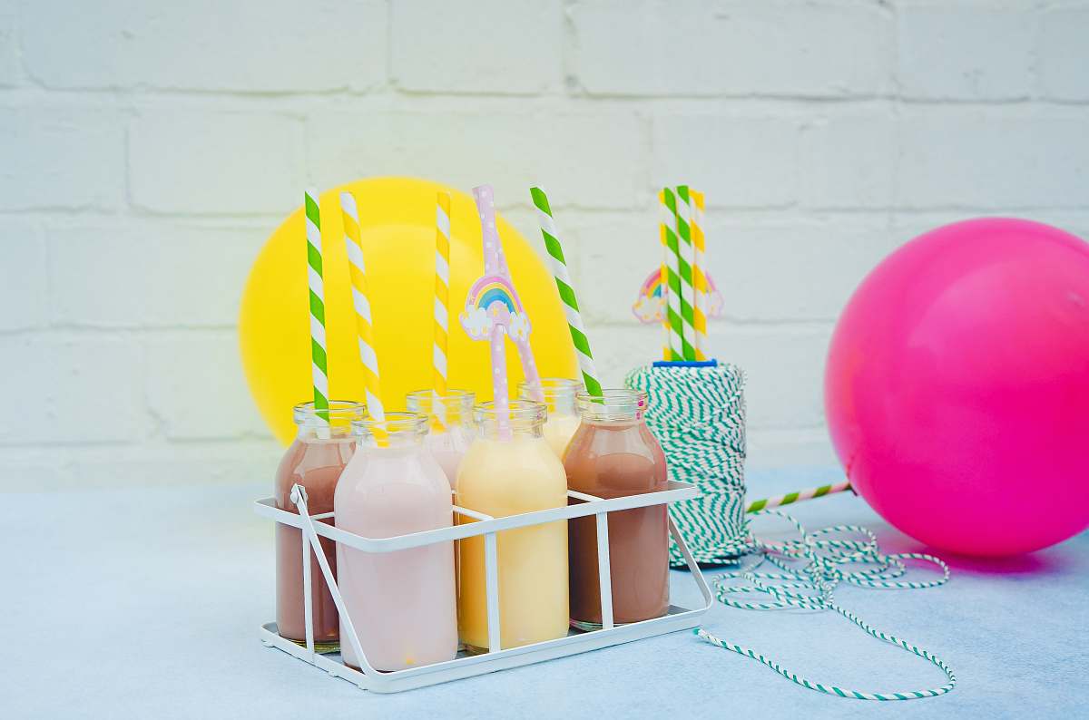 party several glass bottles on white steel rack london