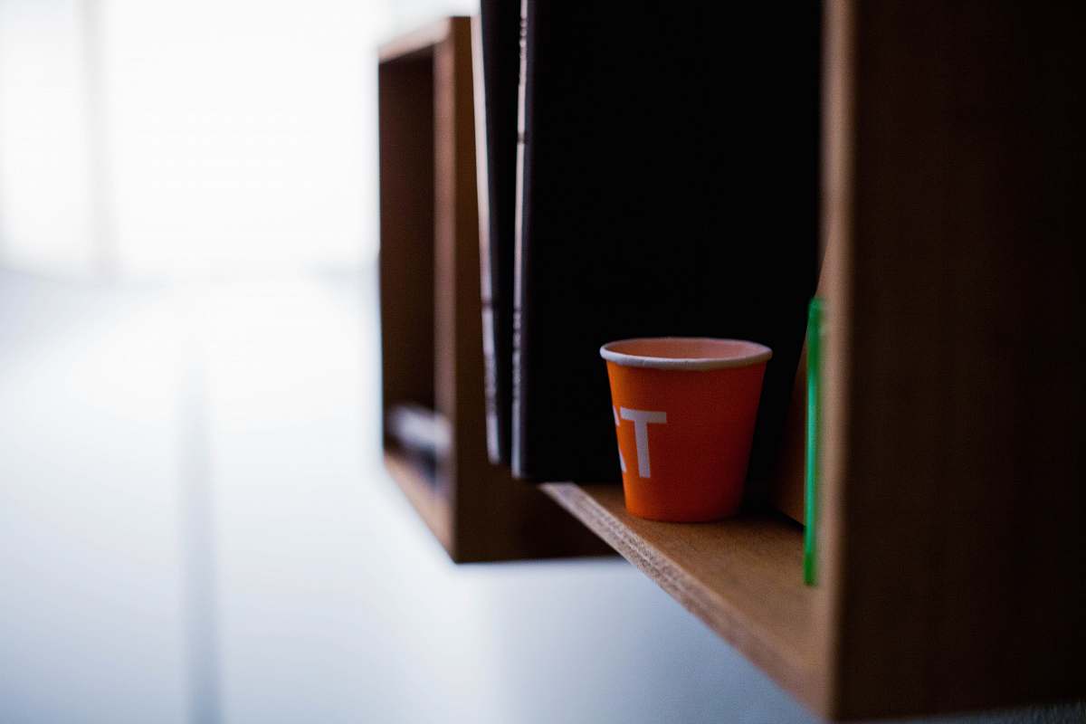shelving red disposable cup on brown wooden shelf shelf