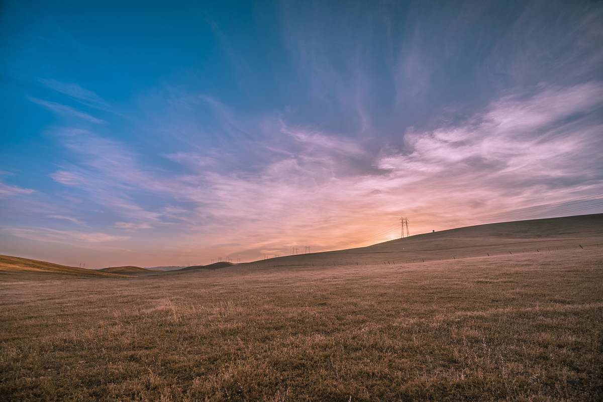 field landscape photography of brown field under blue sky outdoors