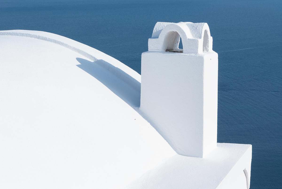 alphabet white structure near body of water during daytime text