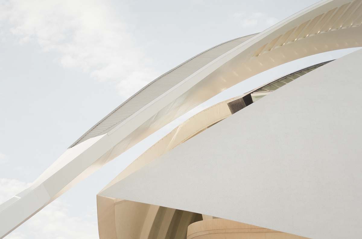 building A long arch at the edge of a modern white facade sky