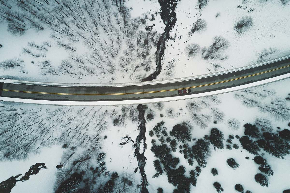 snow brown vehicle travelling on road during daytime aerial