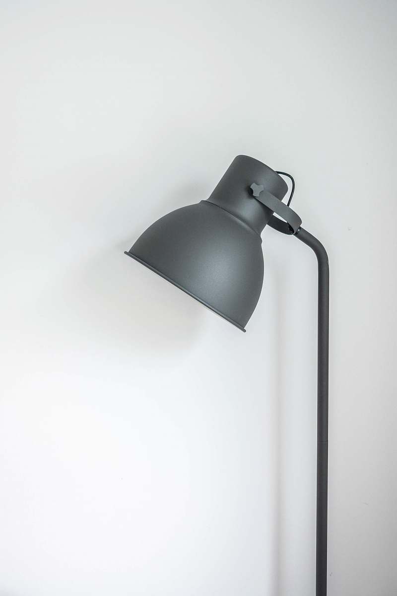 light gray desk lamp near white wall interior