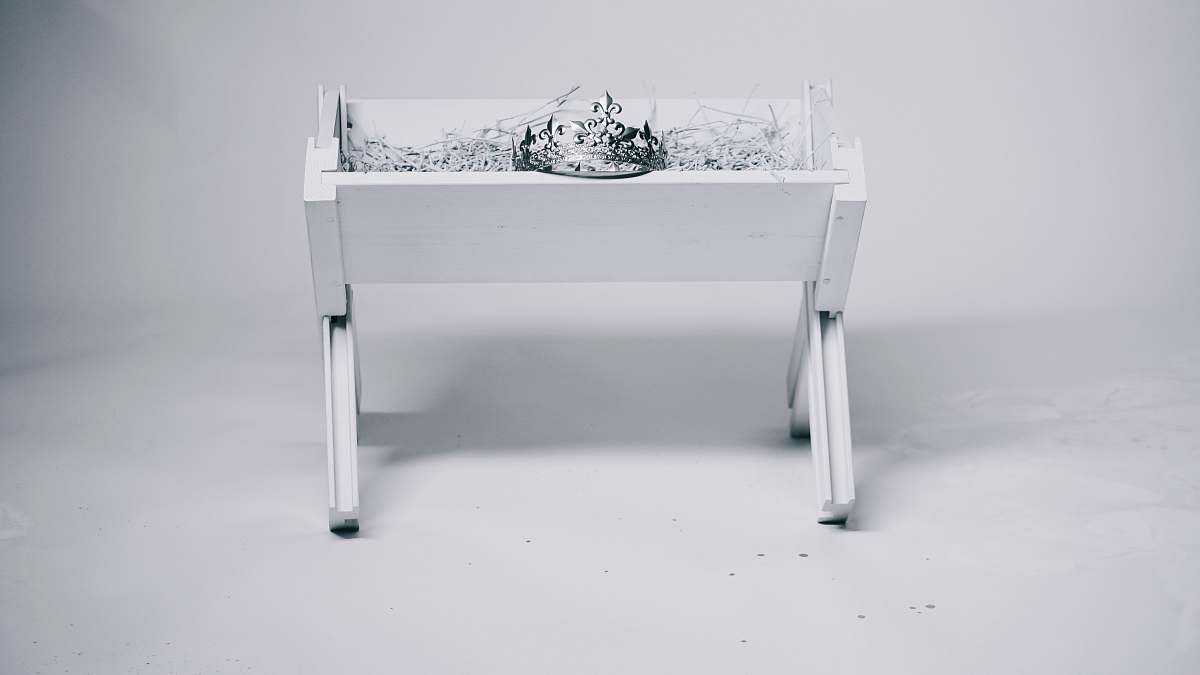 christmas grayscale photography of tiara on table manger
