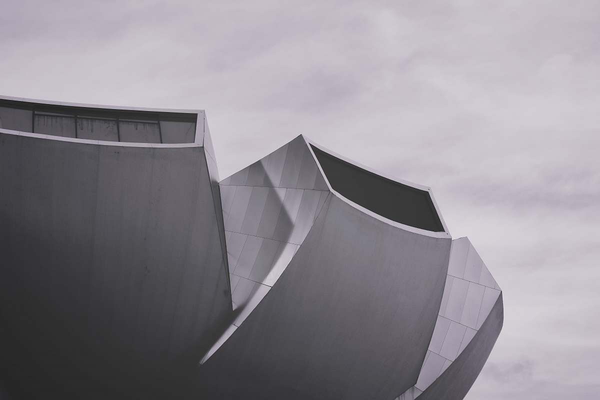curve grey and white architectural building under daytime sky ] line